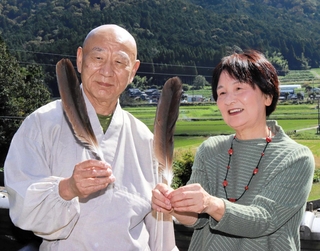 コウノトリの羽根を大切に保管している岩田雅之住職（左）と照美さん＝丹波篠山市真南条中