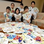 うちわのイラストを描いた氷丘中学校美術部員と禰宜の松崎正誠さん＝日岡神社