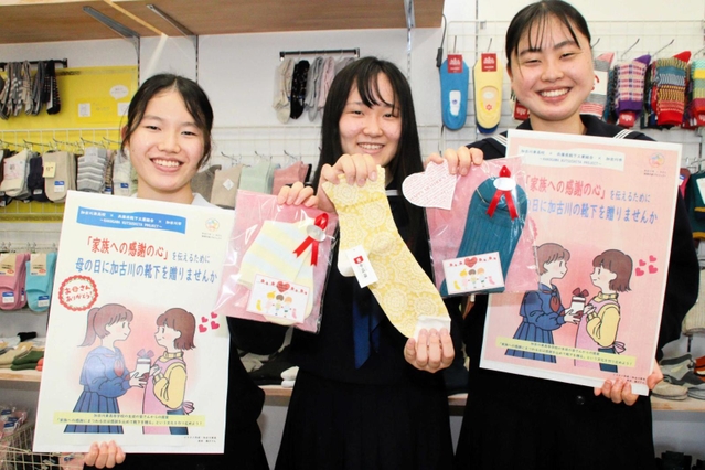 母の日に靴下を贈ることを呼び掛けている加古川東高校の塩見珠梨さん（左）、高田楓子さん（中）、小川明莉さん＝加古川市加古川町篠原町、かこがわ工房Ｋｉｐｓ