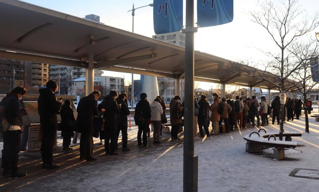 ＪＲ加古川駅前のバス停には、バスを待つ人々が長い列をつくった＝２５日午前７時３１分、加古川市加古川町篠原町