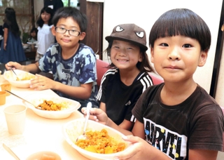 初開催の「カレー食堂」を訪れ、笑顔を見せる子どもたち＝加古川市加古川町寺家町