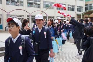 ５年生が作った花道をくぐる卒業生＝上荘小学校