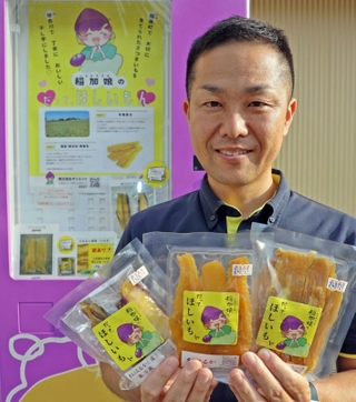 自動販売機で購入できる「稲加娘」と東田春彦社長＝加古川市野口町良野