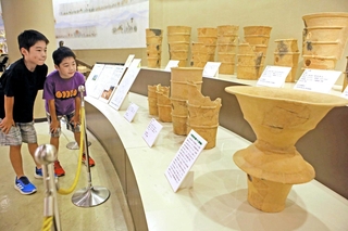行者塚古墳から出土した大小様々な遺物が並ぶ会場＝加古川市平岡町新在家