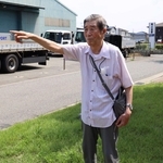 尾上公民館前の道路が戦時中は加古川飛行場の滑走路だったことを説明する上谷昭夫さん＝加古川市尾上町池田