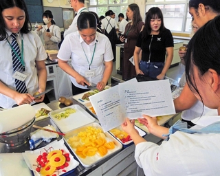 英語のレシピを作り、フレイザー高生にフルーツサンドの作り方を説明する県農生＝県立農業高校