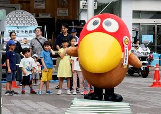 　横断歩道を渡る時のお手本を示す「キョロちゃん」＝２０日午前、横浜市のＪＲ鶴見駅前