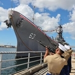 　日本が降伏文書を調印した戦艦ミズーリのそばで、礼砲を撃つ米海兵隊員ら＝２日、米ハワイ州真珠湾の埠頭（ロイター＝共同）