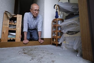 　高羽奈美子さんが殺害されたアパートの玄関に残る犯人のものとみられる血痕を見つめ、取材に応じる夫悟さん＝昨年１１月、名古屋市