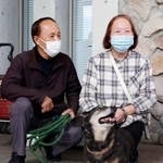 　愛犬のミノと約１日半ぶりに再会した渡辺敏夫さん（左）と妻の寿賀子さん＝２０日午前、大分市佐賀関