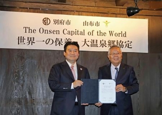 　連携協定を締結した大分県別府市の長野恭紘市長（左）と由布市の相馬尊重市長＝２３日午前、由布市