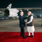 　インドのモディ首相（右）と握手するロシアのプーチン大統領＝４日、ニューデリー（インド外務省提供、共同）