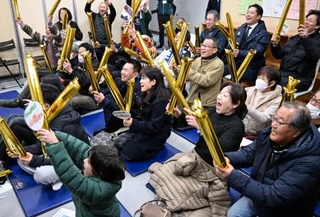 　パブリックビューイング会場で、スノーボード女子ビッグエアの村瀬心椛選手の活躍に盛り上がる人たち＝１０日早朝、岐阜市