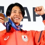 　記者会見を終え、メダルを手にポーズをとる、フリースタイルスキーの堀島行真＝１７日、イタリア・ミラノ（共同）