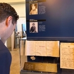 　２０日、米サンフランシスコで内覧会が開かれた日系人兵士の特別展で千人針を見る来場者（共同）