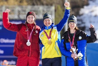 　金メダルを獲得したバイアスロン女子７・５キロ立位の表彰台で、ポーズをとるウクライナのオレクサンドラ・コノノワ（中央）＝７日、テーゼロ