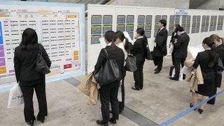 　就職情報会社が開いた合同説明会で掲示板を見る学生ら＝２０２５年２月、千葉市