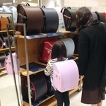 　新宿高島屋のランドセル特設売り場で、品定めする親子＝１８日、東京都渋谷区