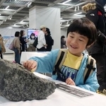 　南極について学ぶイベントで、岩石に触れる子ども＝２１日午後、広島市中区