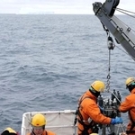 　氷山が浮く海から観測機器を引き揚げるしらせ乗員＝２６日、南極海・トッテン氷河沖（南極観測隊同行記者）