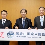 　御嶽山の国定公園指定を受け、記念撮影する（左から）岐阜県の江崎禎英知事、石原環境相、長野県の阿部守一知事＝１０日午後、環境省