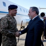 　１５日、イランの首都テヘランの空港で、アラグチ外相（右）に迎えられるパキスタンのムニール陸軍元帥（ロイター＝共同）