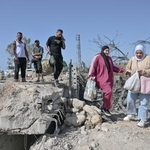 　イスラエルの攻撃で破壊された橋を渡ろうとする人々＝１６日、レバノン南部スール近郊（ゲッティ＝共同）