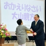 　母校を訪問し、小学６年生の時の担任から花束を受け取る大山親方（右）＝１７日、埼玉県所沢市