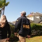 　容疑者の自宅近くで聞き込みに回るＦＢＩの捜査官＝２６日、カリフォルニア州トーランス（ＡＰ＝共同）