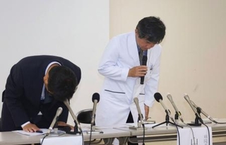 　記者会見で謝罪する桑名市総合医療センターの山田典一病院長（右）ら＝２１日午後、三重県桑名市