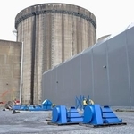 　スリーマイルアイランド原発２号機の原子炉建屋（中央奥）と建屋につながる廃炉作業用のハッチ＝４月、米ペンシルベニア州（共同）