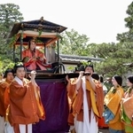 　色鮮やかな平安装束姿で出発する、葵祭のヒロイン「斎王代」の塩見真桜さん＝１５日午前、京都市