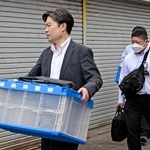 　若山哲夫容疑者の自宅から押収物を運び出す捜査員＝２０日午前１０時５５分、新潟県胎内市