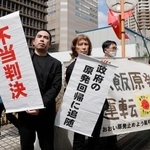 　関西電力大飯原発３、４号機を巡る訴訟の控訴審判決を受け、「不当判決」などと書かれた垂れ幕を掲げる住民側＝２８日午後、大阪高裁前