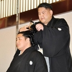 　断髪式で師匠の阿武松親方から最後のはさみを入れられる元十両勇磨＝６日、東京・両国国技館