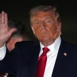 　米東部メリーランド州のアンドルーズ空軍基地で大統領専用機から降りる際に手を上げるトランプ大統領＝９日（ＡＰ＝共同）