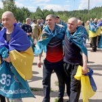 　捕虜交換でウクライナに戻り、笑顔を見せる兵士ら＝２６日、北部チェルニヒウ州（共同）