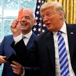 　米ホワイトハウスの執務室でレッドカードを手にするトランプ大統領（右）と、国際サッカー連盟（ＦＩＦＡ）のインファンティノ会長＝２０１８年８月（ロイター＝共同）
