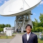 　電波望遠鏡の前に立つ国立天文台野辺山宇宙電波観測所の西村淳所長＝６月、長野県南牧村