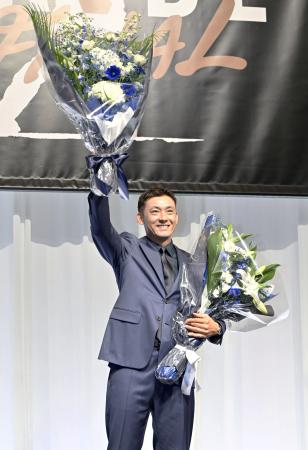 　引退試合を前に開かれた記者会見で、花束を手にする西武の栗山巧外野手＝３０日、東京都内