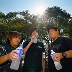　厳しい暑さとなり、水分補給する子どもたち＝３日午前、熊本県八代市