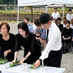 　豪雨災害から１７年となり、「復興ひろば」で献花する遺族＝９日午前、兵庫県佐用町