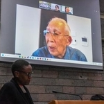 　２日、ケニア・ナイロビの国連事務所で開かれた会合にオンライン参加し核兵器廃絶を訴える中村富洋さん（撮影・中野智明、共同）