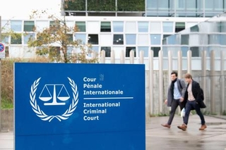 　オランダ西部ハーグの国際刑事裁判所（ＩＣＣ）前を歩く関係者ら＝９日（共同）
