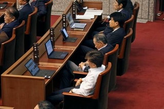 　埼玉県議会の本会議で疲れた様子の県議＝１７日午前０時４７分