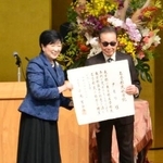 　東京都庁で開かれた名誉都民の顕彰式で、小池百合子知事（左）から称号記を受け取るタモリさん＝１日午前