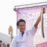 　イタリア・コマッキオで開かれたウナギ祭りで、さばいたウナギを見せる田舎庵の緒方仁さん＝３日（共同）