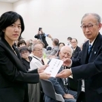 　厚労省担当者に要請書を提出する被団協の浜住治郎事務局長（右）＝９日午前、国会