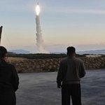 　３日、北朝鮮東部で行われた中距離戦略ミサイルの発射訓練を視察する金正恩朝鮮労働党総書記（右）と娘（朝鮮通信＝共同）