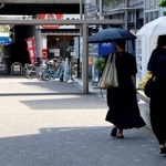 　ＪＲ前橋駅前を日傘を差して歩く人たち＝５日午後